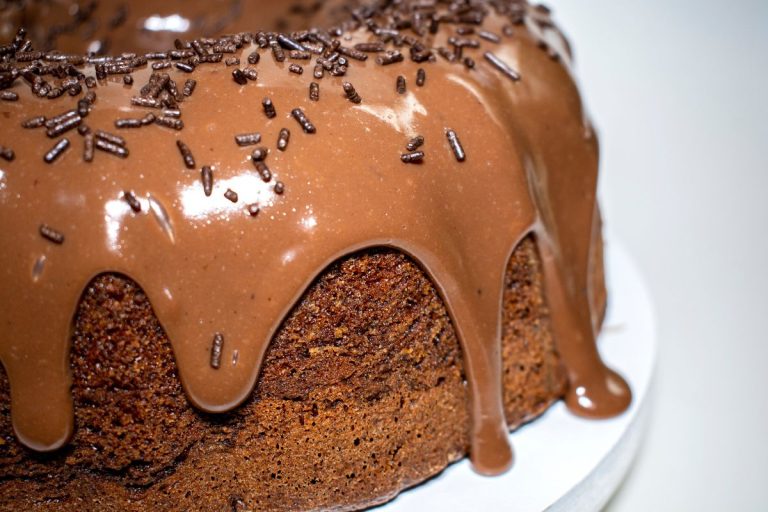 fazer bolo de chocolate: um bolo de chocolate com cobertura e granulado.